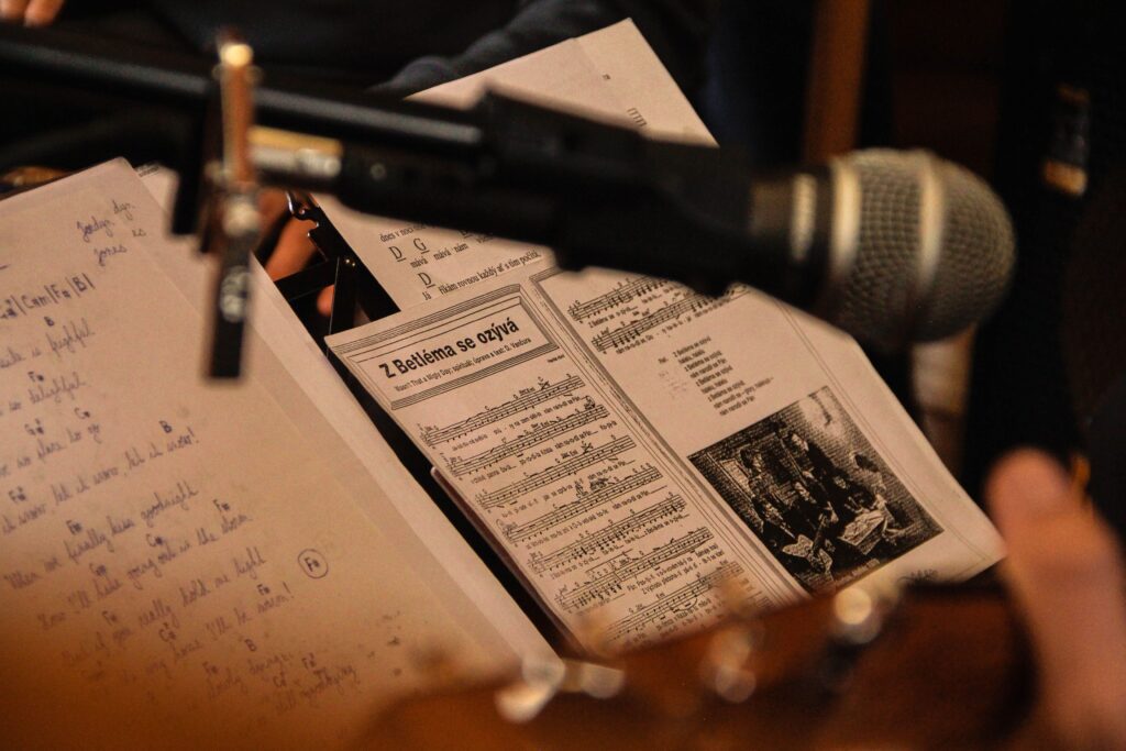 Close-up of sheet music with a microphone in a performance setting, capturing a musical moment.